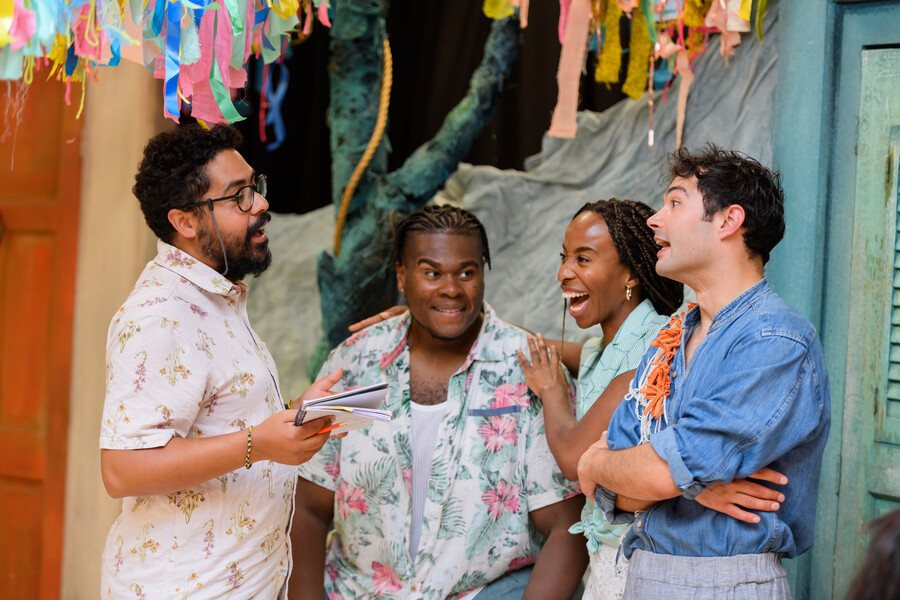 Royal Shakespeare Company. Image of a group of actors talking and laughing together. Photo by Joe Bailey